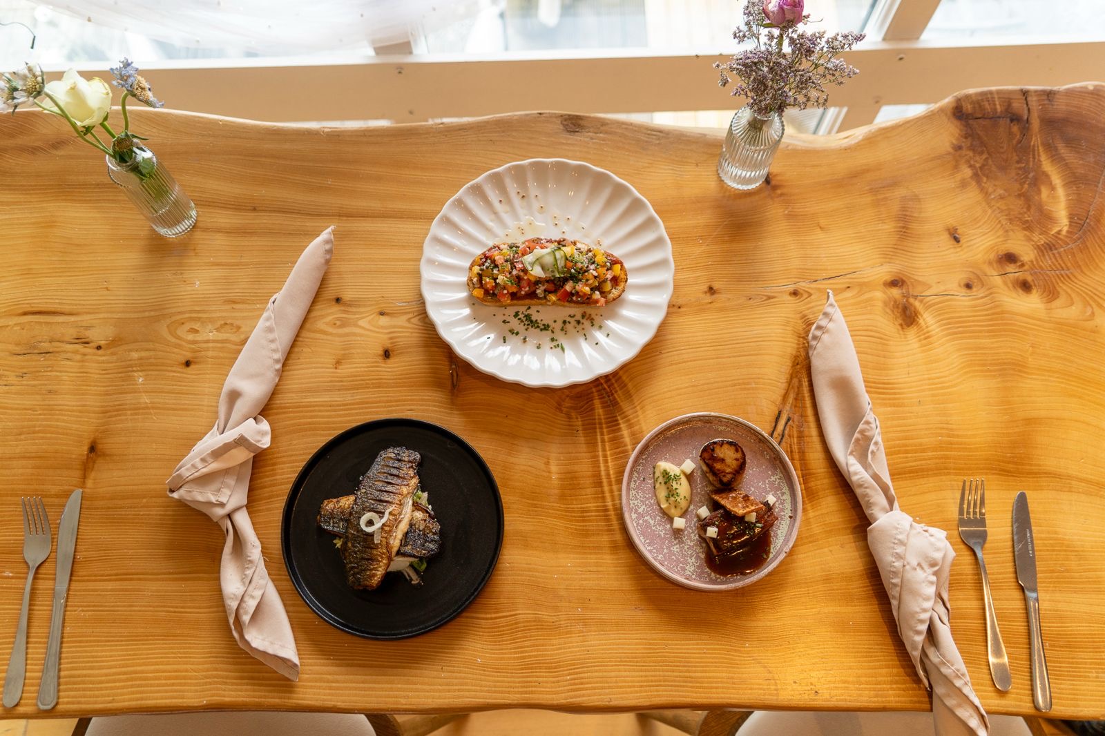 Dishes set out along the table by the window